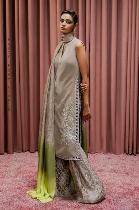 Woman in a tailored Indian ensemble with taupe kurta, wide-leg pants, and lime-green ombre dupatta